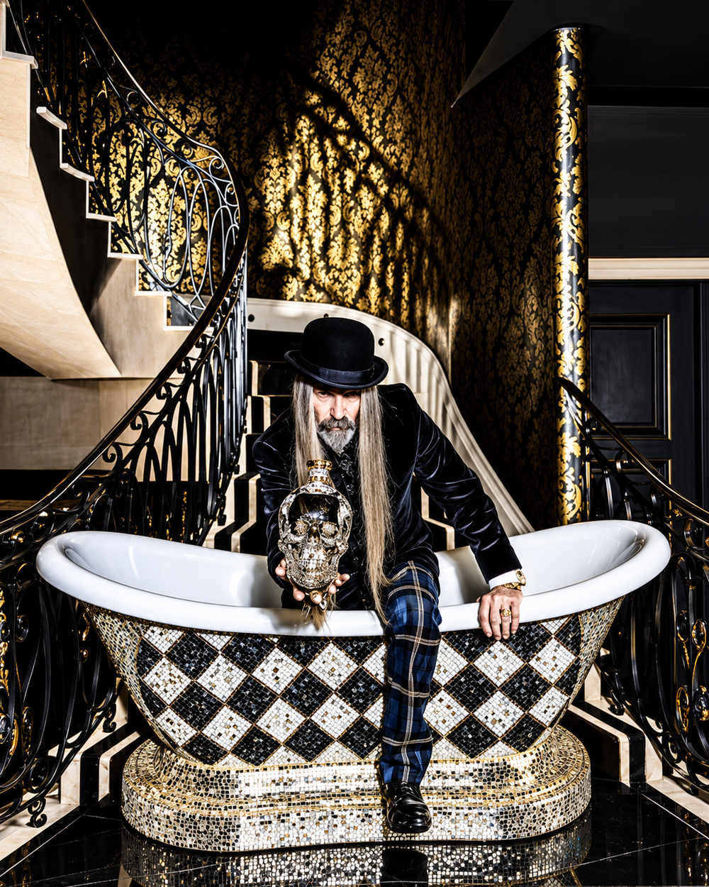 A gilded sculptural object displayed in a dark gallery